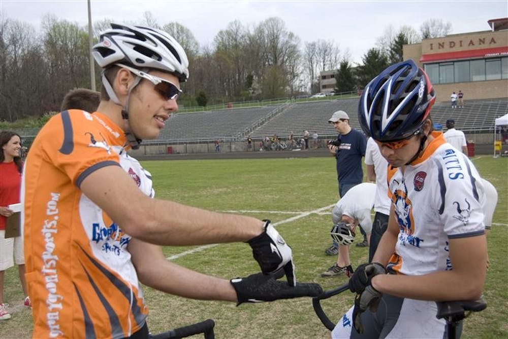 Sophomore Ryan Kiel talks strategy with sophomore Zach Trodgon before Gray Goat Cycling’s heat at Team Pursuit on April 18 at Bill Armstrong Stadium. Kiel and his brother, junior Matt Kiel, formed Gray Goat Cycling and named it after a bike shop in Indianapolis.