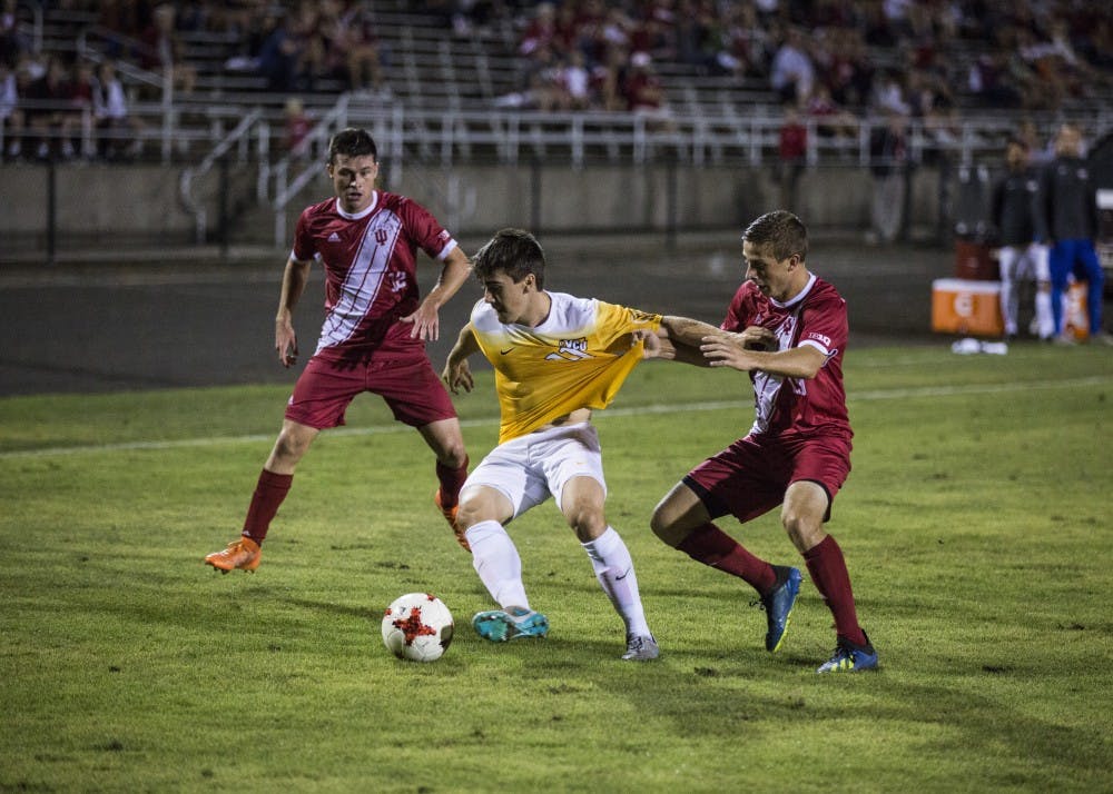 <p>Virginia Commonwealth University midfielder Fortia Munts holds off IU senior Rece Buckmaster on Sept. 7 at Bill Armstrong Stadium. The Hoosiers are 4-0 in Big Ten Conference play this season.&nbsp;</p>