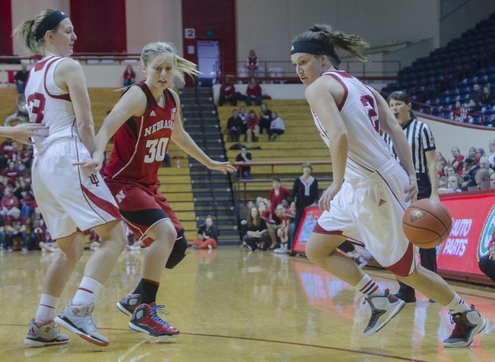 Freshman guard Jess Walter dribbles behind her back while freshman forward Amanda Cahill sets a screen against Nebraska at Assembly Hall during the Hoosier's final home game of the season. IU lost 67-64. 