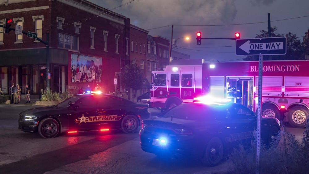 Sheriff’s department cars and a Bloomington Fire Department truck sit with their lights flashing at the intersection of Sixth and Walnut Streets after multiple protesters were hit by a car just after the conclusion of the protest July 6 in downtown Bloomington. The protest was in response to a racist attack on Monroe County human rights commissioner Vauhxx Booker on July 4.