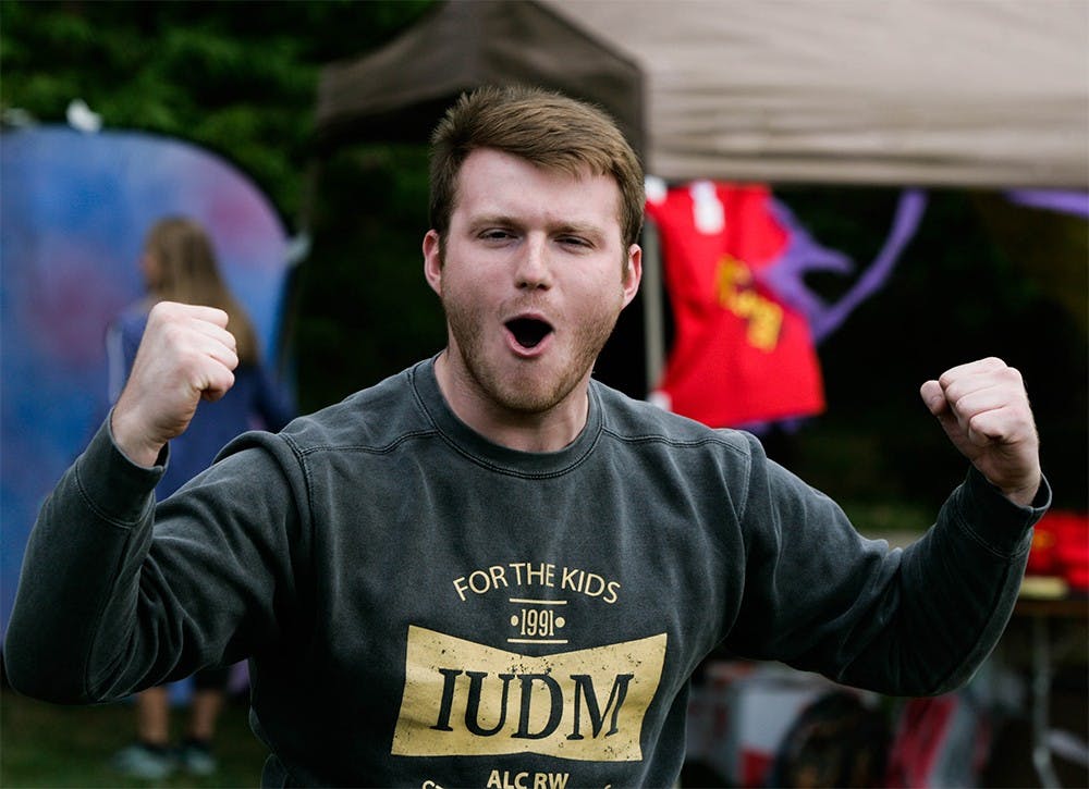 Junior Taylor Burden celebrates after hitting a ballon in a game of dart toss at Phi Delta Epsilon's philanthropic event Stand for the Kids in support of Riley's Children Hospital. The event took place Thursday in Dunn Meadow in honor of their brother Nick Wolfe, who died from injuries sustained in an accident on Sept. 3. 