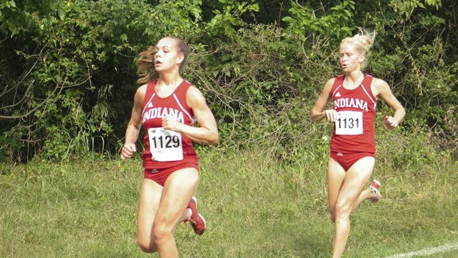 Sophomore Sarah Pease leads teammate senior Kristina Trcka in the 27th Annual Indiana Intercollegiates meet Friday at the IU course. Pease and Trcka finished 5th and 8th respectively to help the team to a second place finish.