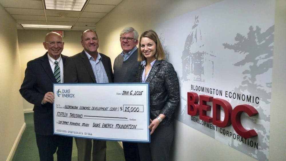 Members of the Bloomington Economic Development Corporation receive the Duke Energy Economic and Workforce Development grant for land use planning for Interstate 69.