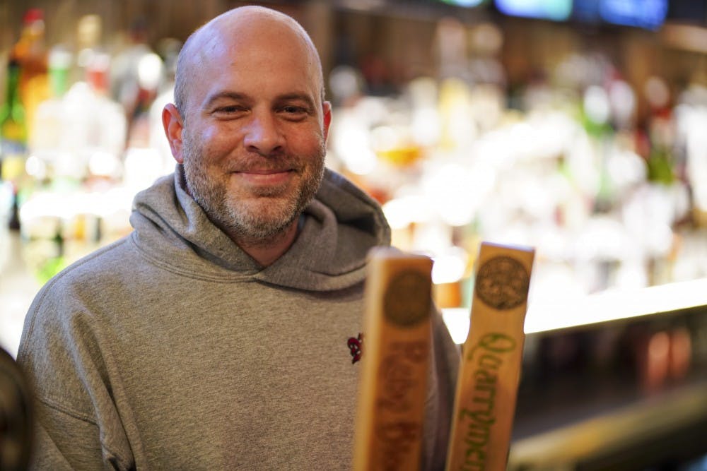 <p>Pete Mikolaitis, general manager of Nick's English Hut, shares a laugh with employees behind the bar Monday evening. Mikolaitis discussed how Nick’s prepares for Little 500 weekend here in Bloomington.</p>