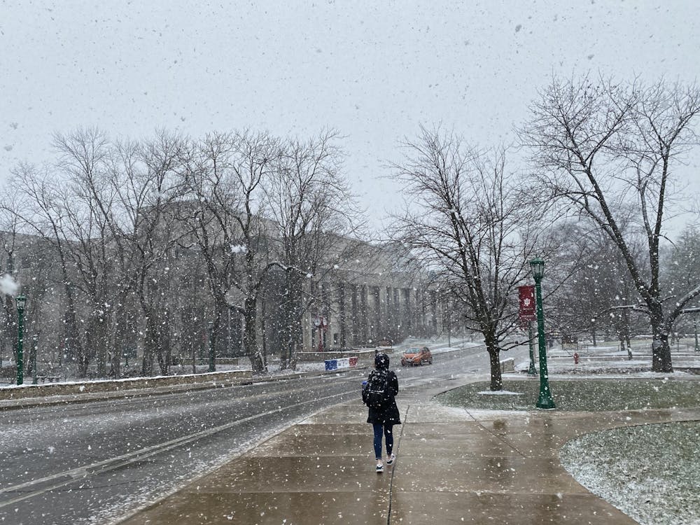 An IU student walks through the snow Feb. 9 on Jordan Avenue. Bloomington is expected to receive up to an inch of snow late Tuesday, according to the National Weather Service. 