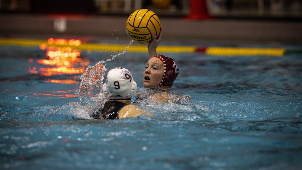 Sophomore attacker Skylar Kidd is guarded while she looks for a pass against Harvard in the Hoosier Invite on Jan. 28, 2023 at Counsilman-Billingsley Aquatic Center.