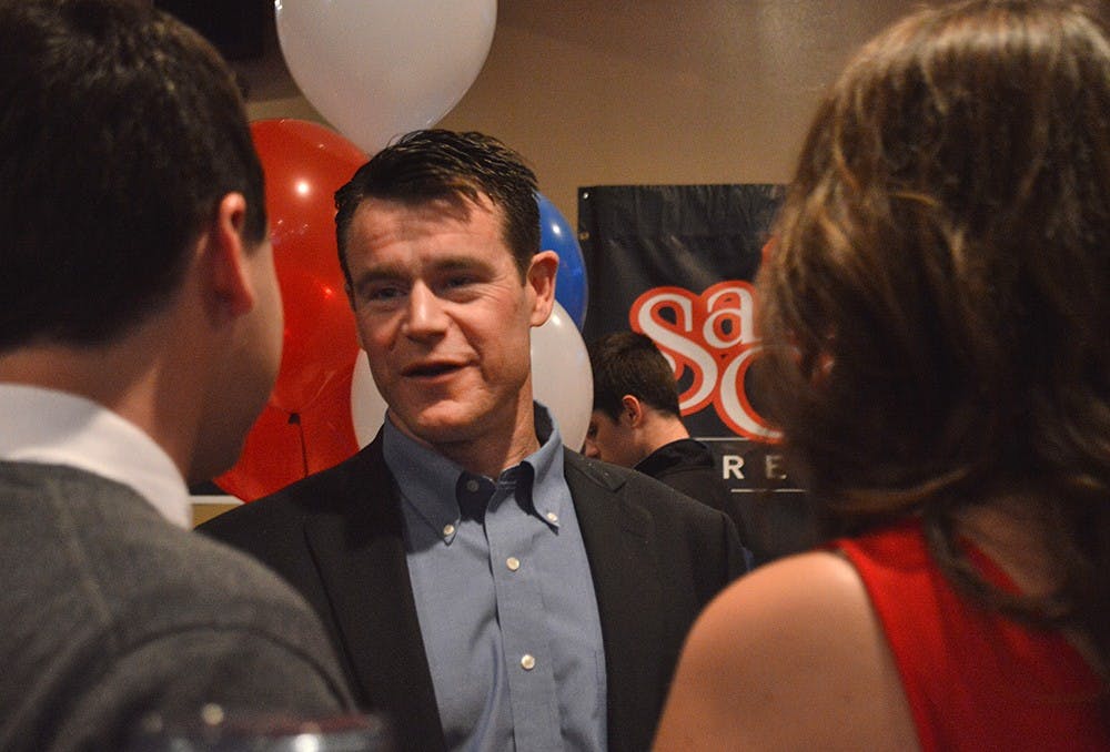 Republican candidate Todd Young speaks with Bloomington residents upon arrival at the election party. 