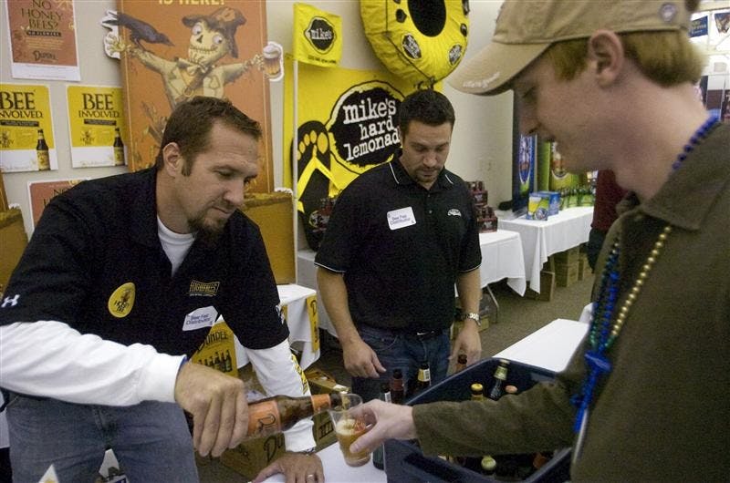 Robb Drancik of High Falls Breweing Company pours a Dundee Pale Bock for Skye Maddox at the 16th Annual Big Red Beerfest Thursday evening.   Dundee Ales & Lagers donate a percentage of  their proceeeds to Colony Collapse Disorder research in order to study decilnes in honey bee populations.