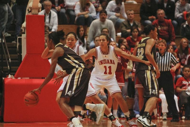 Senior Forward Whitney Thomas and Senior Guard/Forward Kim Roberson successfully prevent a Purdue offensive player from making a basket. After a very close first half, the Hoosiers won 71-57 against the Boilermakers Monday evening at Assembly Hall.