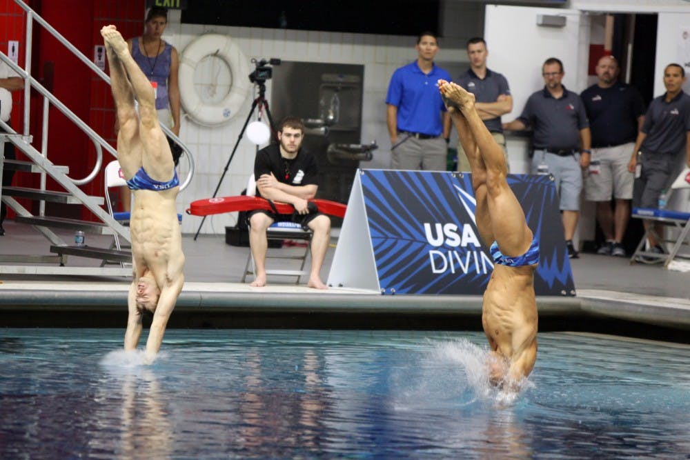 Michael Hixon, left, and Samuel Dorman, right, dive during the men's synchronized 3-meter  springboard preliminaries at the 2016 U.S. Olympic Team Trials in Indianapolis Saturday. 