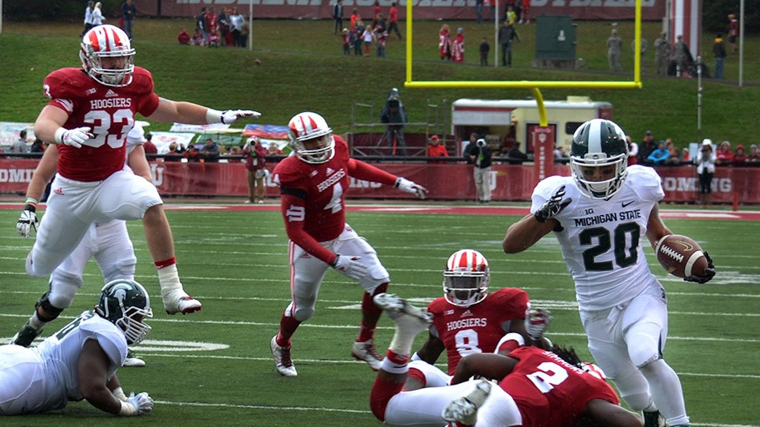 The IU defense tries to tackle Michigan State running back Nick Hill in the homecoming game against the Spartans on Saturday at Memorial Stadium.