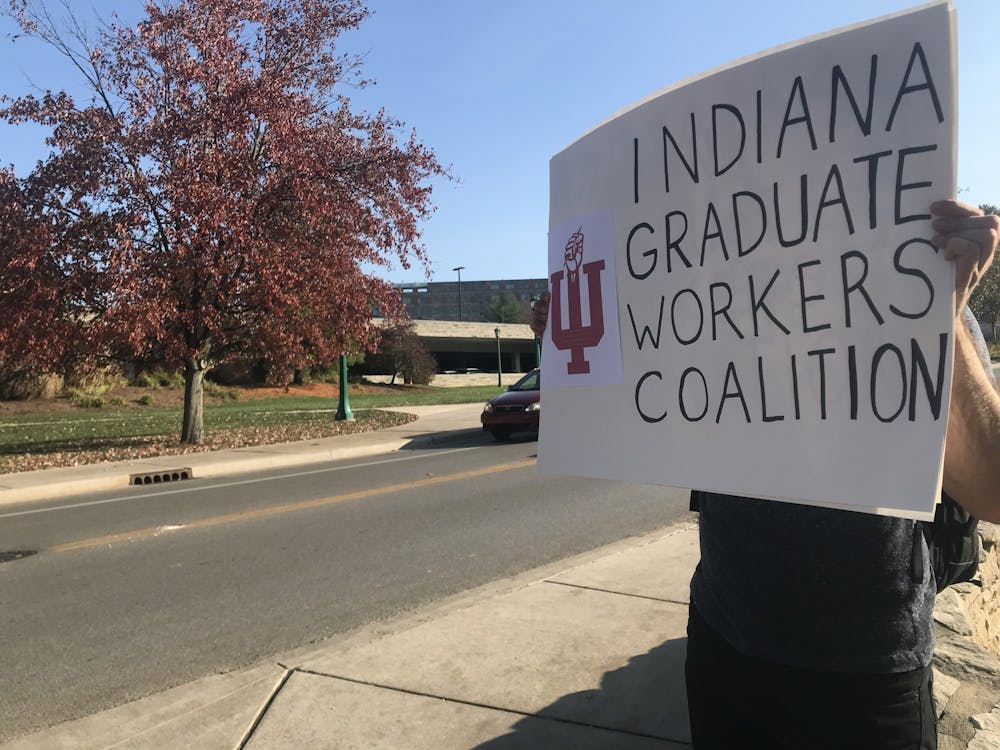 <p>Members of the Indiana Graduate Workers Coalition protest Nov. 10 on Jordan Avenue. The members protested on behalf of Jacobs School of Music students and performers.</p>