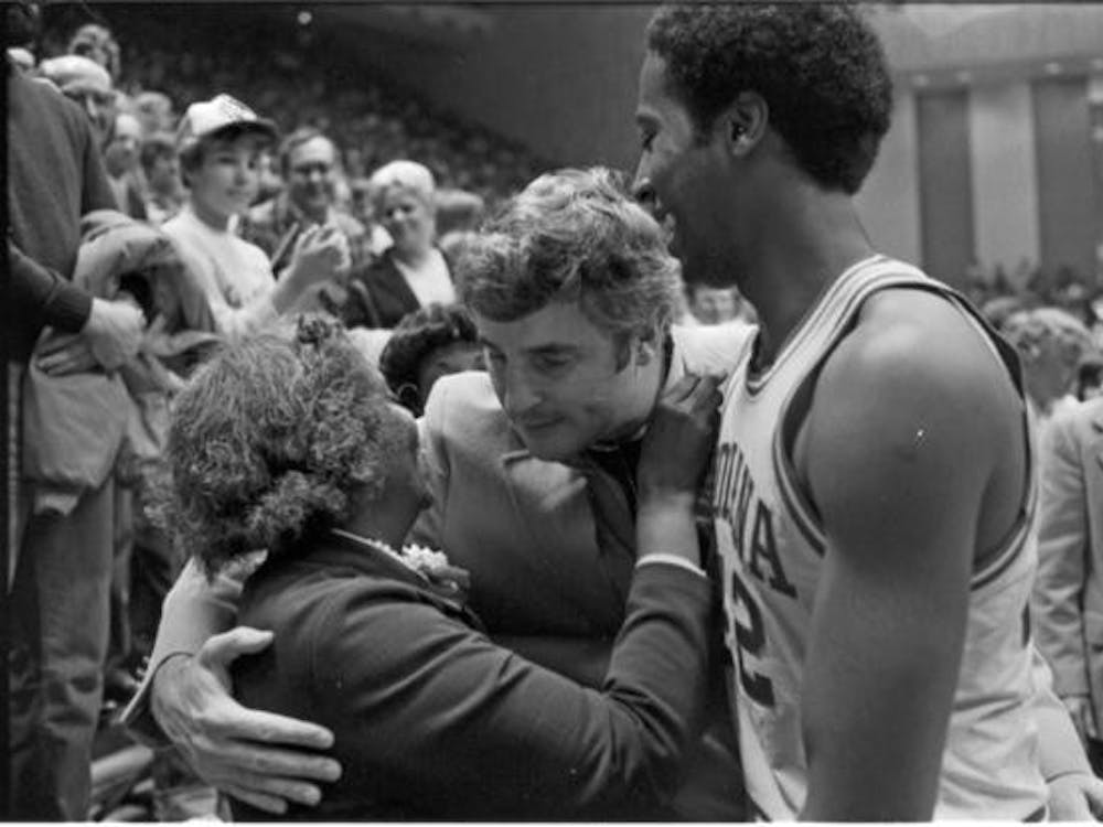 Former IU basketball player Mike Woodson celebrates with his mother and former IU basketball coach Bob Knight after a game in 1980 at Ohio State. IU hired Woodson to be the new men&#x27;s basketball coach Sunday.