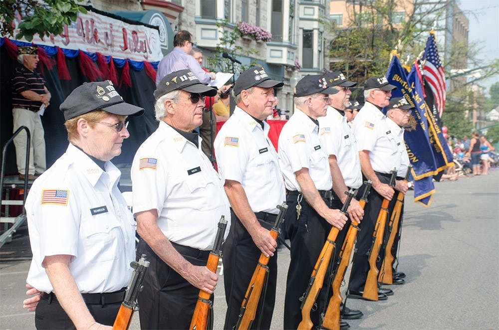 Veterans of The American Legion Burton Woolery Post 18 stand on Kirkwood Avenue which the Fourth of July Parade would pass on Saturday. The Parade is hosted by Bloomington Parks and Recreation and Downtown Bloomington, Inc. and is sponsored by The American Legion Burton Woolery Post 18. 