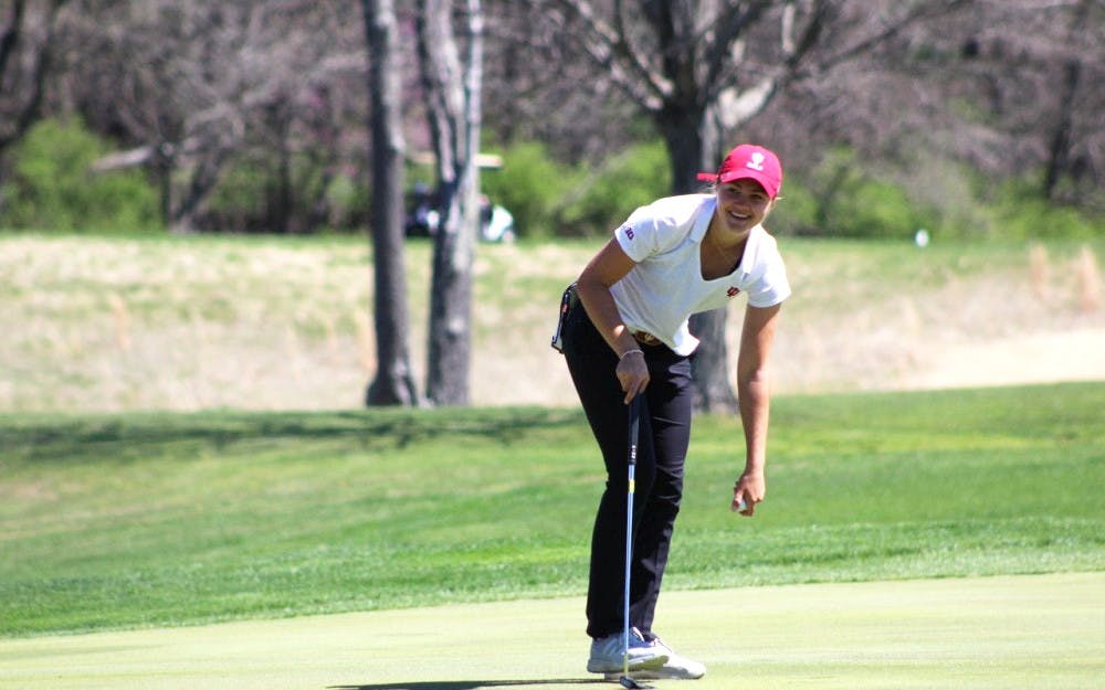 <p>Then-freshman Emma Fisher picks her ball out of the hole after sinking a putt April 8, 2017, during the IU Invitational at the IU Golf Course. IU shot 19-over-par during the Westbrook Invitational Feb. 23-24 in Peoria, Arizona.</p>