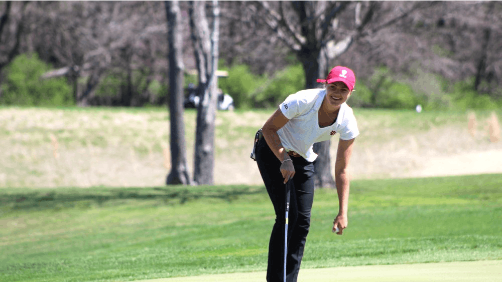 Then-freshman Emma Fisher picks her ball out of the hole after sinking a putt April 8, 2017, during the IU Invitational at the IU Golf Course. IU shot 19-over-par during the Westbrook Invitational Feb. 23-24 in Peoria, Arizona.