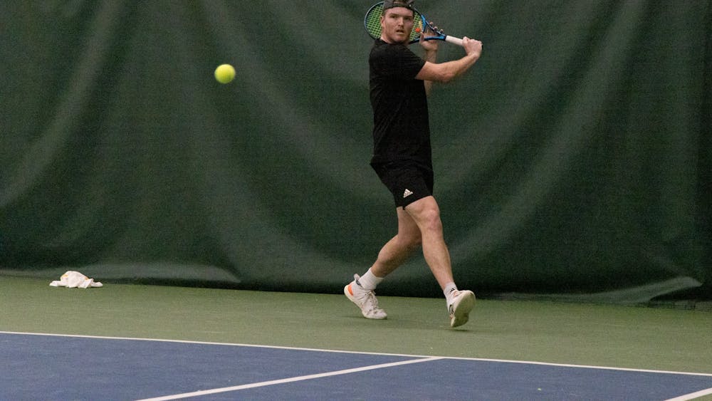 Senior Patrick Fletchall sets up to return a serve and put underspin on the ball on Feb 12, 2023, at the IU Tennis Center.
