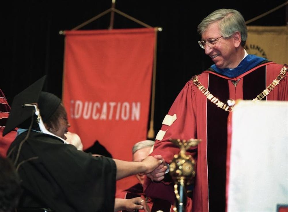 Myles Brand greets a student at commencement during Brand's tenure as IU president.