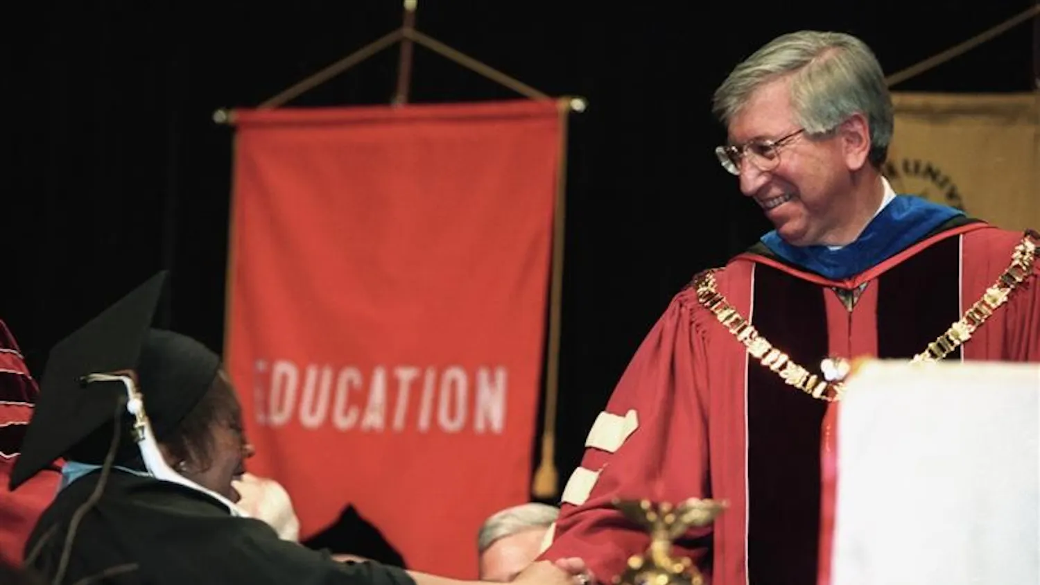 Myles Brand greets a student at commencement during Brand's tenure as IU president.