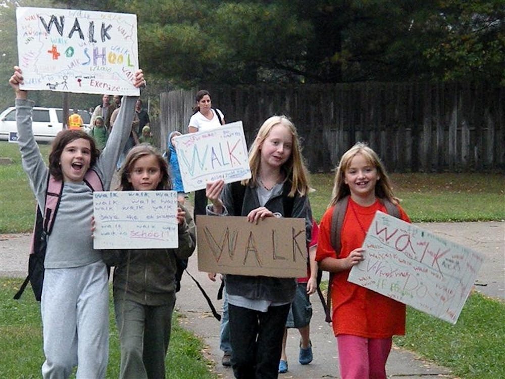 Students walk to school Wednesday morning as part of International Walk to School Day. Hundreds of students at all grade levels participated.