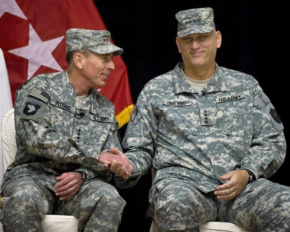 Gen. David Petraeus, left, and Lt. Gen. Ray Odierno, who rises to four-star rank, take part in a a formal change-of-command ceremony at the main U.S. military headquarters in Baghdad on Tuesday, Sept. 16, 2008. Odierno took over from Gen. David Petraeus.
