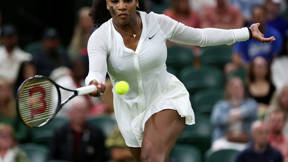 Serena Williams plays a forehand against France&#x27;s Harmony Tan during their first-round Wimbledon match at All England Lawn Tennis and Croquet Club on June 28 in London. She announced her retirement from the sport on Aug. 9.