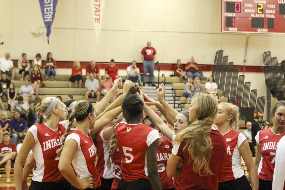 The team gathers during a time out during game two, as they are only points away from winning during the IU Volleyball game against Evansville Saturday afternoon at University Gym.