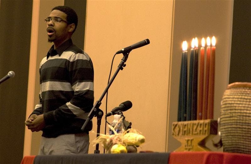 Justin Merrick sings a spiritual piece as part of the pre- Kwanzaa celebration. The celebration, put on by the Arts of the African Diaspora, was held at the Neal-Marshall Black Culture center on Thursday.
