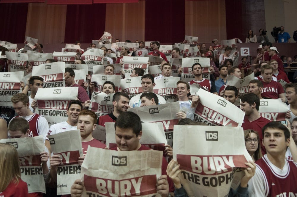 Members of the Crimson Guard hold up "Bury the Gopher" newspapers before the game against Minnesota on Saturday at Assembly Hall. The Hoosiers won 74-48.