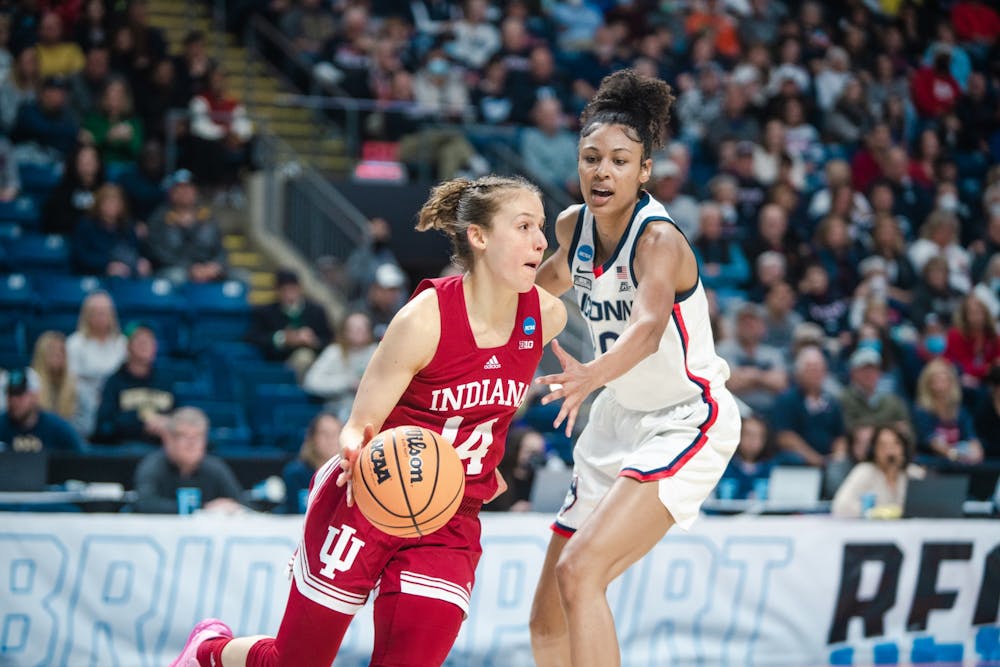 <p>Senior guard Ali Patberg dribbles around a University of Connecticut defender Mar. 26, 2022, at Total Mortgage Arena in Bridgeport, CT. Indiana lost 75-58 against UConn.</p>