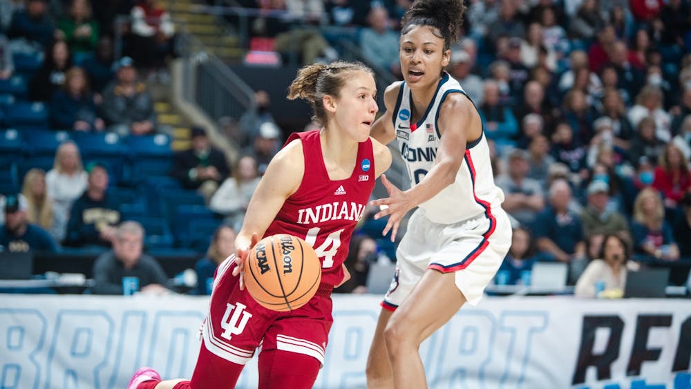 Senior guard Ali Patberg dribbles around a University of Connecticut defender Mar. 26, 2022, at Total Mortgage Arena in Bridgeport, CT. Indiana lost 75-58 against UConn.
