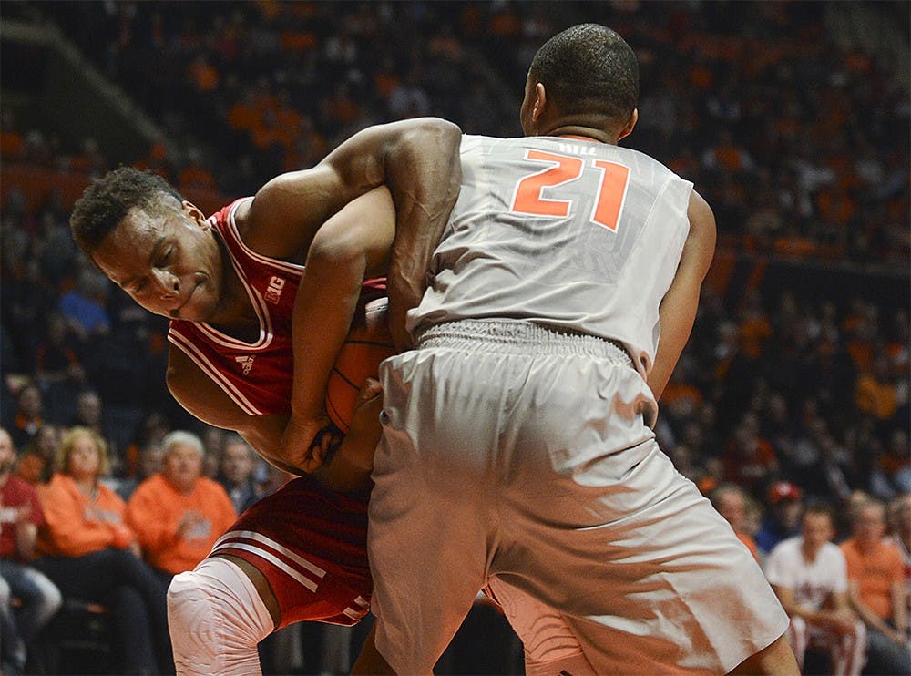 Senior guard Yogi Ferrell fights for the ball with Illinois guard Malcolm Hill Thursday at the State Farm Center in Champaign. Ferrell led the Hoosiers in scoring with 27 points against the Illini, helping IU beat Illinois 74-47.