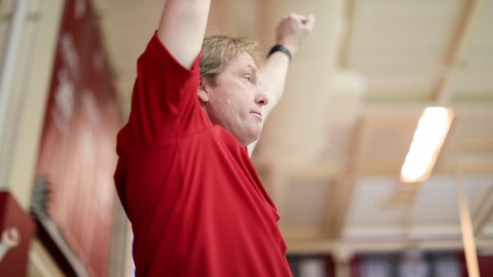IU swimming head coach Ray Looze raises his arms during the Big Ten Tournament meet Feb. 20, 2019 at Counsilman-Billingsley Aquatic Center in Bloomington. Looze is in his 18th year coaching IU and will be inducted into the ASCA Hall of Fame later this year.