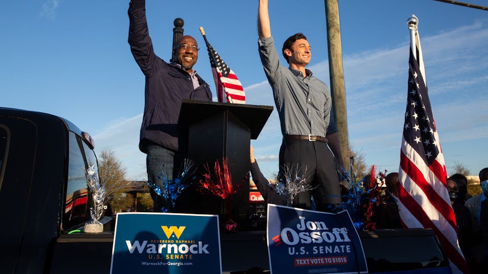 Then-U.S. Senate candidates Jon Ossoff, D-Georgia, and Raphael Warnock, D-Georgia, greet the crowd at a rally on Nov. 15 in Marietta, Georgia. 