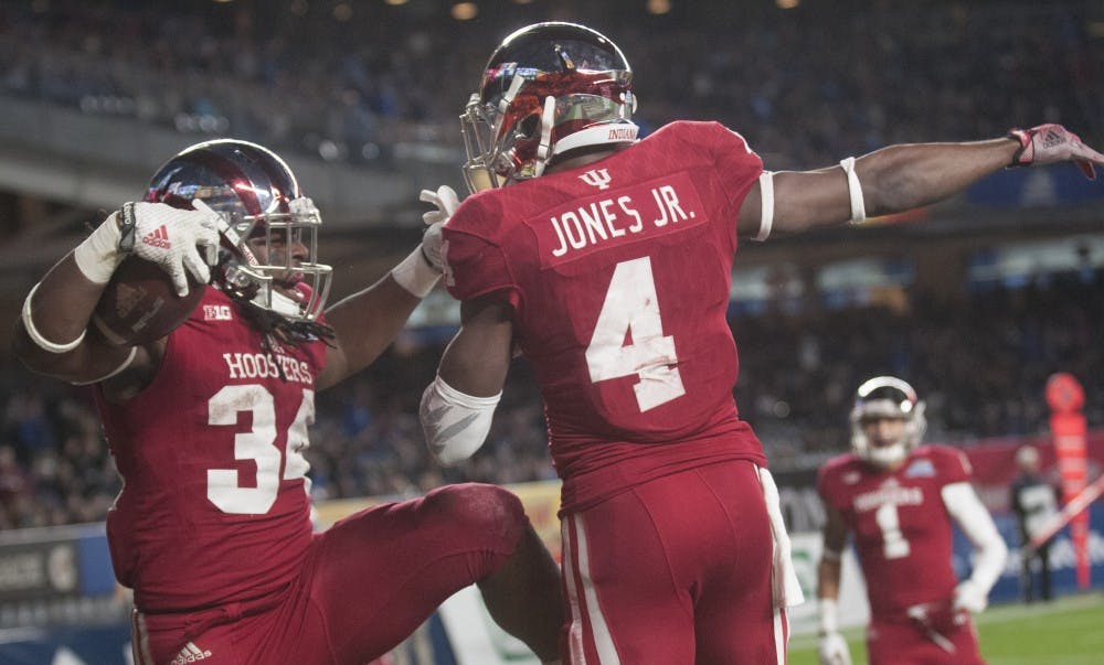 Running back Devine Redding (34) celebrates with wide receiver Ricky Jones (4) after Redding scored during the Pinstripe Bowl against Duke on Dec. 26 at Yankee Stadium.