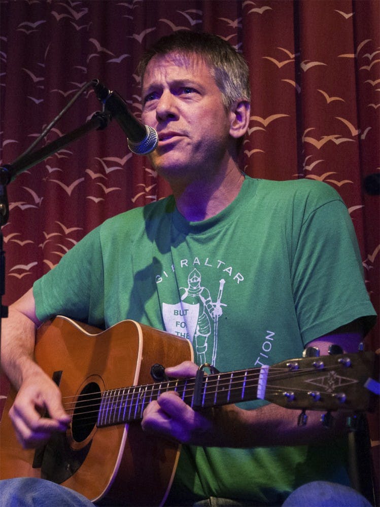 Richard Sullivan performs on the stage on Tuesday evening at the Bear's Place. Sullivan worked for several publications and worked free-lance as well.