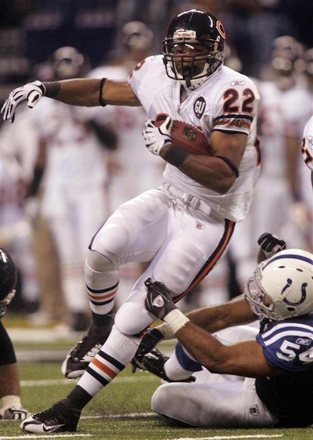 Chicago Bears running back Matt Forte (22) breaks a tackle by Indianapolis Colts linebacker Freddie Keiaho in the second half of an NFL football game on Sunday in Indianapolis.