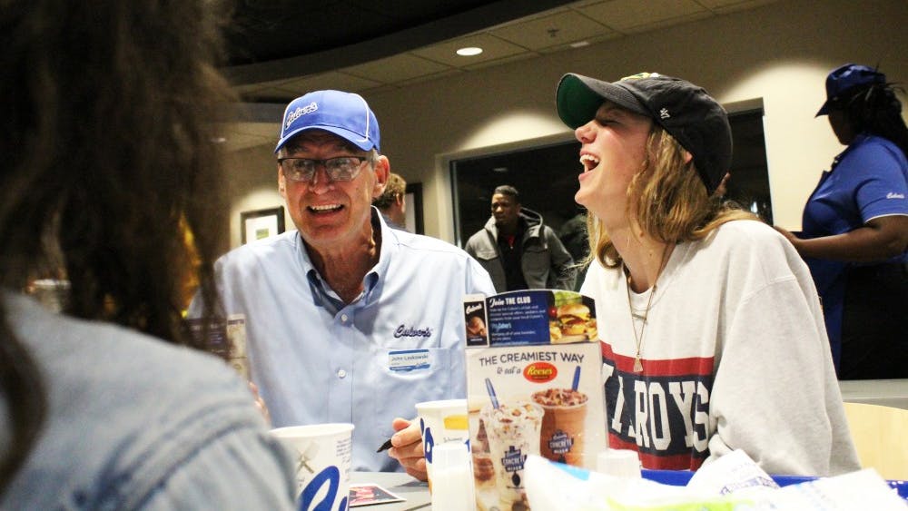 Culver's owner John Laskowski sits and talks with customer Clare Donohue about his IU basketball career Nov. 5 at Culver's opening night. &nbsp;Laskowski played basketball under Bob Knight from 1971 to 1975 and later went on to play for the Chicago Bulls.