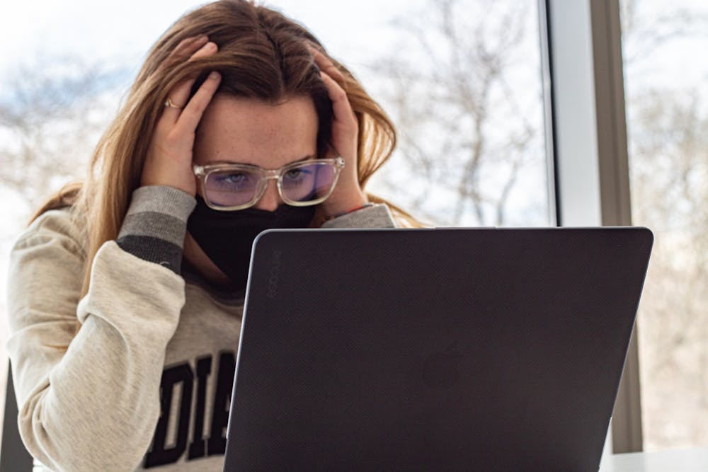 <p>Freshman Emma Gagnon stares frustrated at her laptop. Some students said that they struggle to navigate their courses&#x27; Canvas pages.</p>