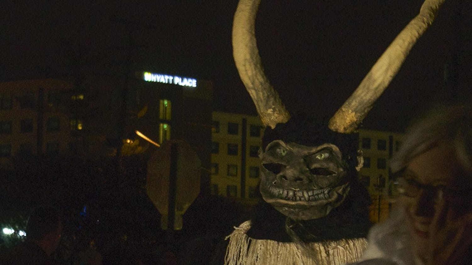People dress up as demonic followers of Krampus, the "Bad Santa," during the Krampus parade Saturday in downtown Bloomington. The creatures walked down Madison Street and taunted people wearing "Naughty" stickers.