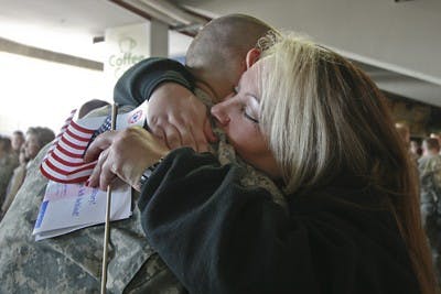 Courtesy PhotoBret Hawkins, 20, hugs his mother Laura Hawkins goodbye before leaving for training camp in Georgia.
