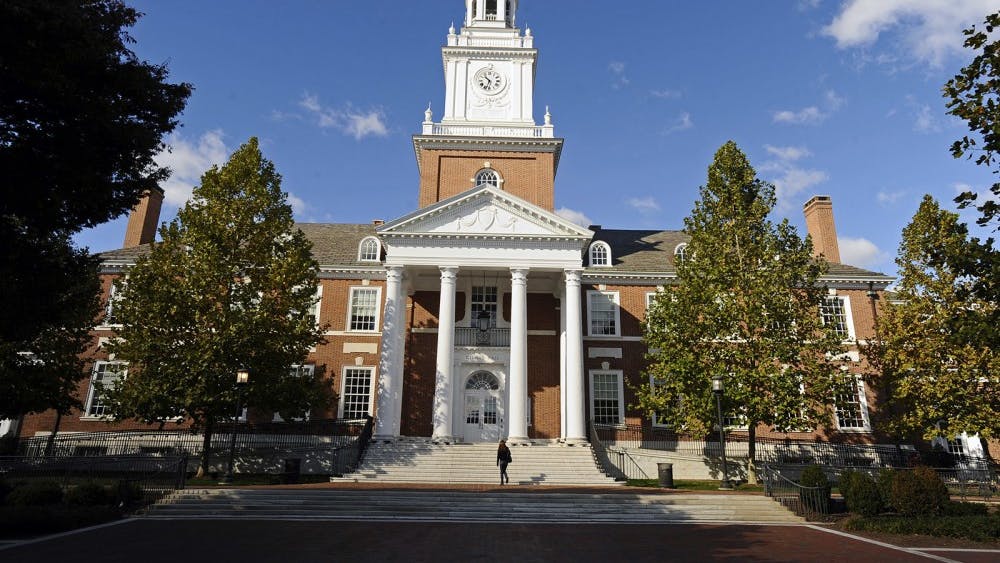 A man walks up the steps of Gilman Hall at Johns Hopkins University. Johns Hopkins University drove out two professors this summer for violating sexual misconduct policies.