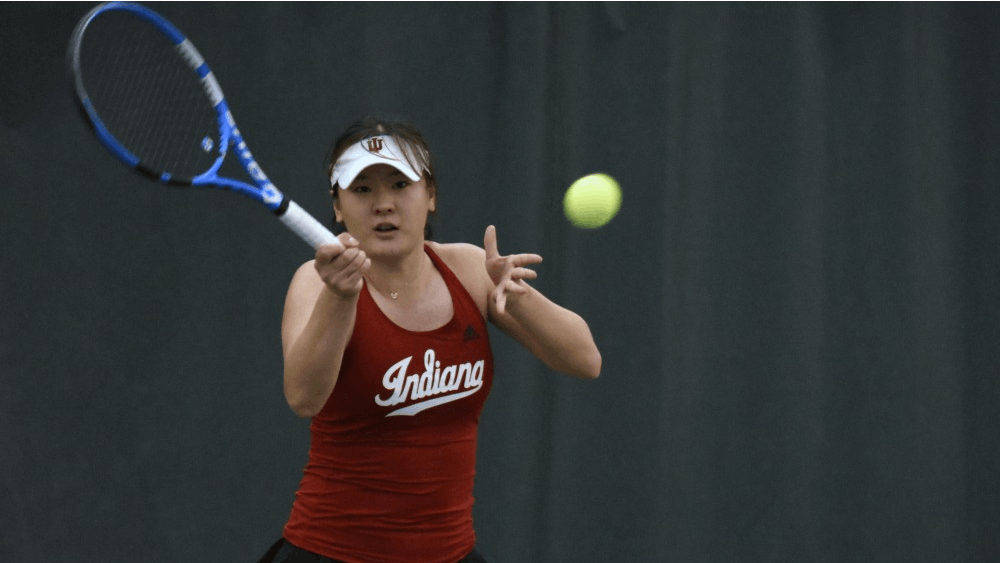Senior Xiwei Cai swings through a forehand during her 6-3, 6-3 singles win over Minnesota. Her win helped the Hoosiers to defeat the Golden Gophers with an overall score of 5-2.