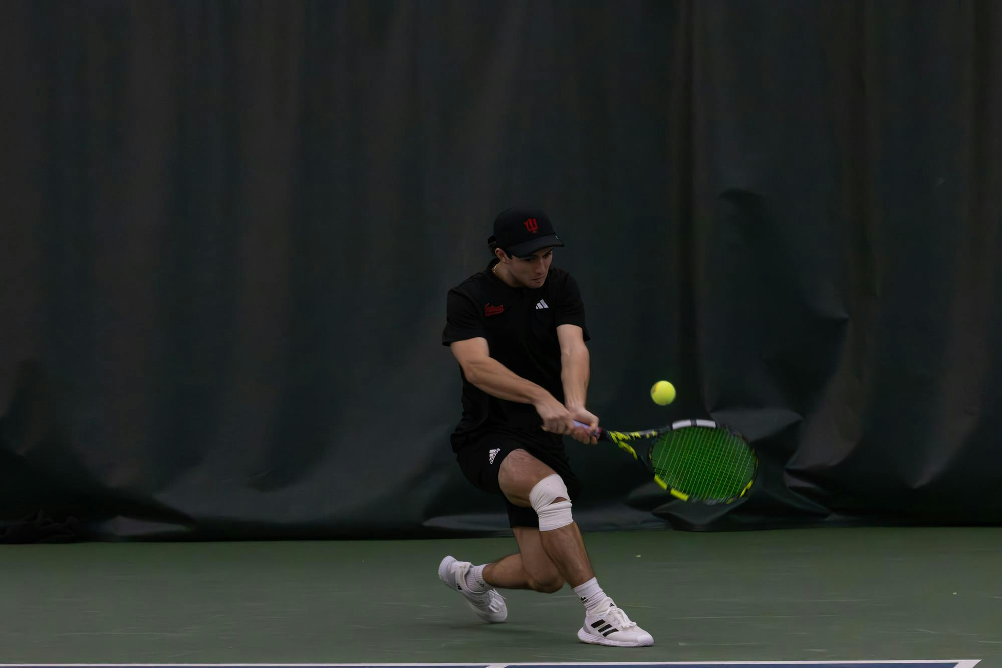 Freshman Braeden Gelletich hits the ball in a match against Memphis on Feb. 23, 2025, at the tennis center in Bloomington. This is Gelletich's first year playing tennis for the Hoosiers.