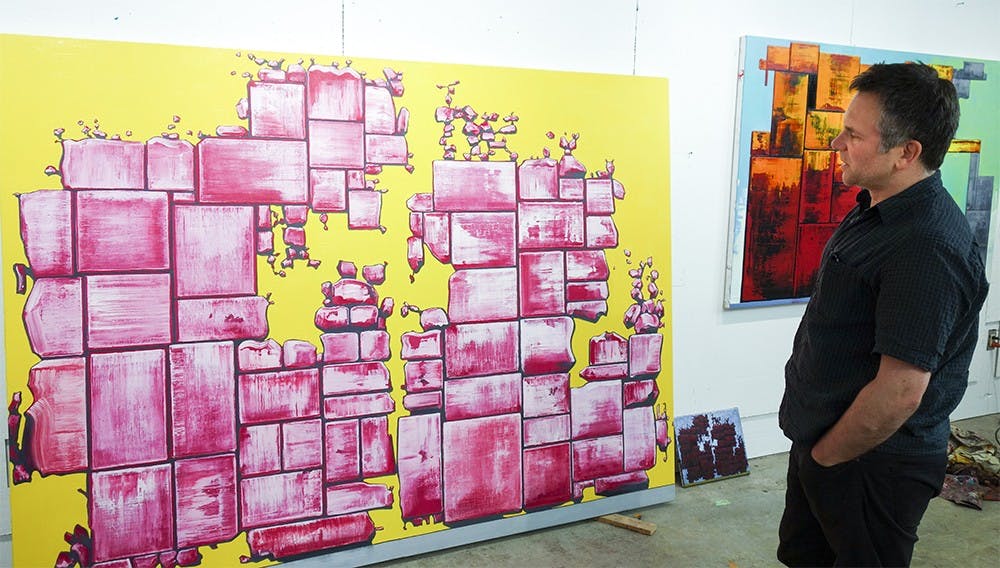 Visiting Assistant Professor of Painting Gabriel Phipps stands in his Bloomington studio space in front of his painting Shelf Life. More of Phipps's works can be seen at www.gabrielalexanderphipps.com.