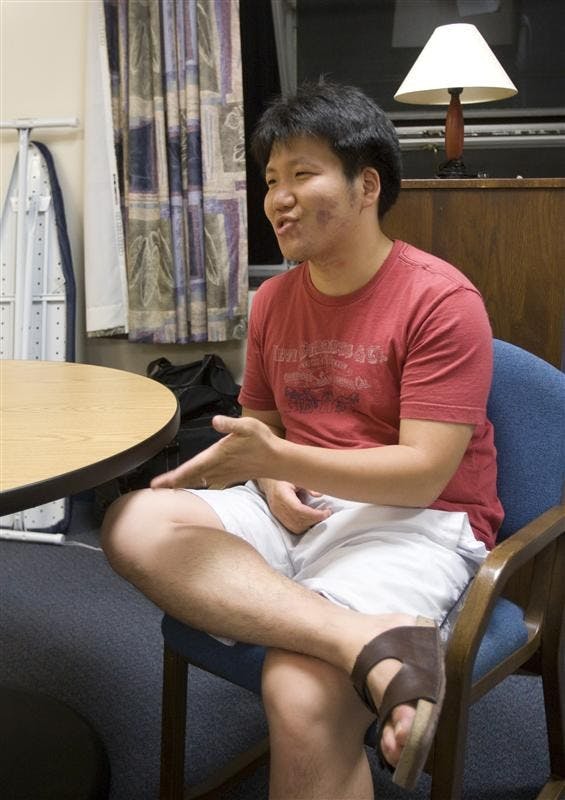 Freshman Suengyeob Kim sits in his dorm room converted from a floor lounge in Read-Curry Wednesday.  In order to accomodate an increasing freshman population, RPS had to place several new students in converted dorm rooms.