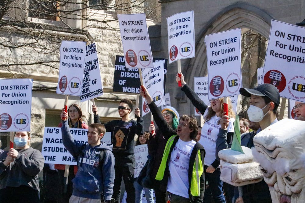 When a car honked in support, demonstraters cheered and hoisted their signs in the air April 14, 2022, outside Sample Gates. Mutiple picket lines are taking place outside IU buildings starting this week as the graduate workers look to be recognized as a union and fight for higher wages.