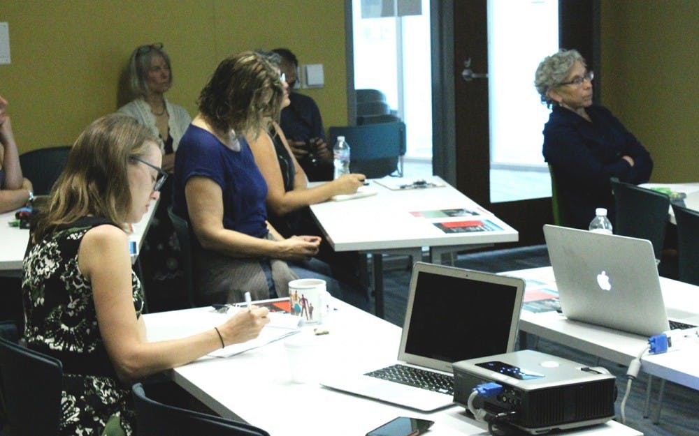 Listening closely, members of the lecture take notes of women in power.