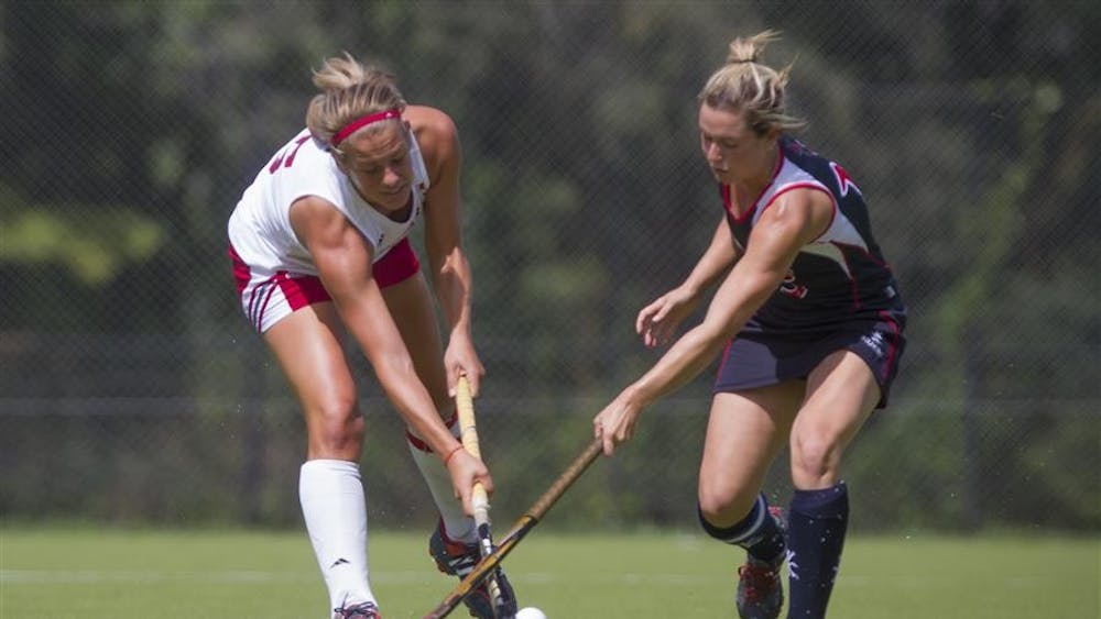 Senior Hannah Boyer tries to get the ball past the defender during IU's match against Robert Morris on Sunday at the IU Field Hockey Complex.
