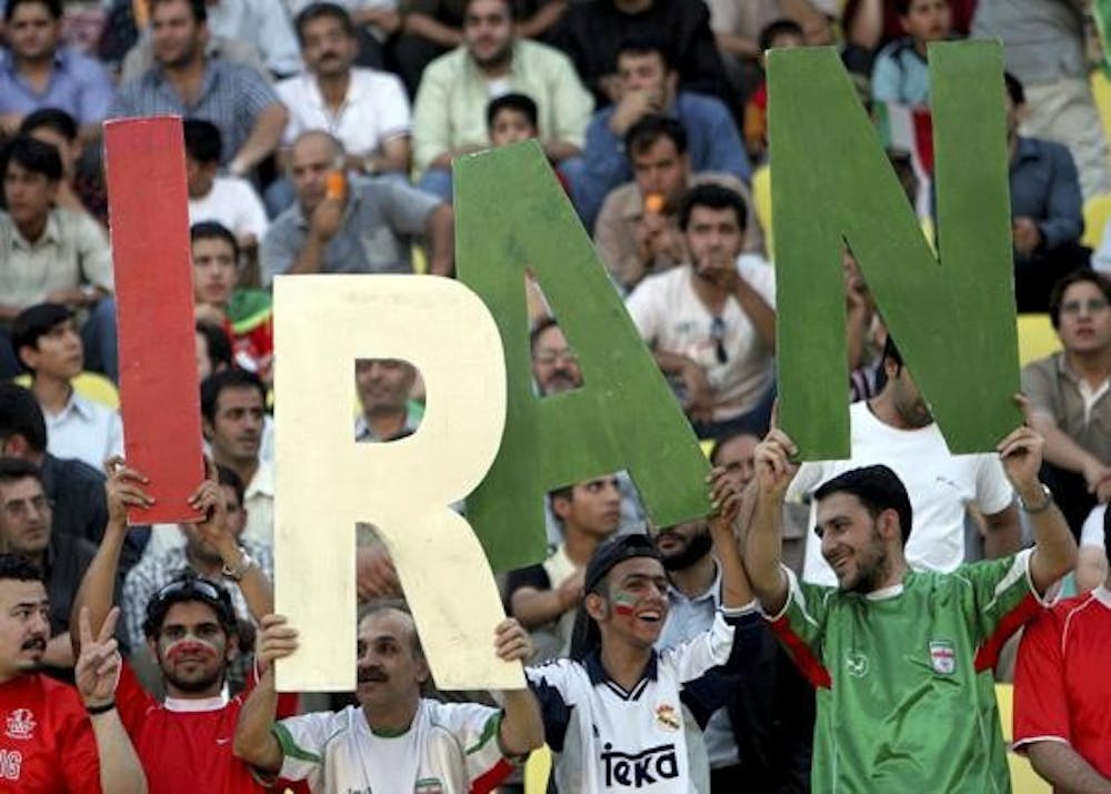 Fans paint their faces with the  color of Iran's national flag in attendance of a freindly match between Iran and Bosnia-Herzegovina in Tehran May 31, 2006.